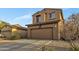 Two-story home featuring a two car garage, neutral color scheme and drought resistant landscaping at 41369 W Parkhill Dr, Maricopa, AZ 85138