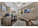 Well-lit home office featuring a desk, ceiling fan, hardwood floors, and large windows at 41369 W Parkhill Dr, Maricopa, AZ 85138