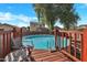 Above ground pool with wooden deck and backyard seating area for outdoor enjoyment at 41369 W Parkhill Dr, Maricopa, AZ 85138
