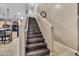 Elegant staircase featuring hardwood steps, neutral tones, and access to the second floor at 41369 W Parkhill Dr, Maricopa, AZ 85138