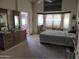 Relaxing bedroom featuring a comfortable bed, dresser, and bay window at 4172 E Graythorn Ave, Phoenix, AZ 85044
