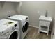 Functional laundry room with a utility sink and modern washer and dryer units at 4253 E Palo Verde St, Gilbert, AZ 85296