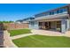 Expansive backyard features artificial turf, a brick paver patio, and desert landscaping at 4253 E Palo Verde St, Gilbert, AZ 85296