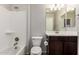 Clean bathroom with a tub-shower combo, dark wood vanity, and modern fixtures at 4253 E Palo Verde St, Gilbert, AZ 85296