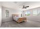 Bright bedroom featuring a ceiling fan and carpeted floors with multiple windows offering natural light at 4253 E Palo Verde St, Gilbert, AZ 85296