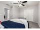 Cozy bedroom with a blue bedspread, carpeted floor, and a closet with sliding doors at 4253 E Palo Verde St, Gilbert, AZ 85296