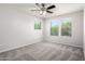 Bright, empty bedroom with neutral carpet and three windows letting in natural light at 4253 E Palo Verde St, Gilbert, AZ 85296