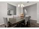 This dining room has a large table, seating for six, and a modern chandelier at 4253 E Palo Verde St, Gilbert, AZ 85296