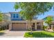 Charming two-story home with a well-manicured lawn, a two-car garage, and a brick-accented front porch at 4253 E Palo Verde St, Gilbert, AZ 85296