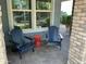 Inviting front porch featuring two Adirondack chairs and a red side table, perfect for relaxing at 4253 E Palo Verde St, Gilbert, AZ 85296