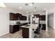 Contemporary kitchen boasting granite countertops, stainless steel appliances, dark cabinets, and an eat-in island at 4253 E Palo Verde St, Gilbert, AZ 85296