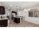 Bright kitchen with granite counters, a stainless steel refrigerator, an island with seating, and modern lighting at 4253 E Palo Verde St, Gilbert, AZ 85296