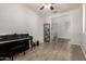 Neutral colored living room with tile floors and a piano off to the side at 4253 E Palo Verde St, Gilbert, AZ 85296