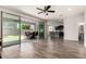 Spacious living room with tile floors, ceiling fan, and sliding glass doors leading to the outdoor patio at 4253 E Palo Verde St, Gilbert, AZ 85296