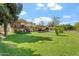 Expansive backyard with a deck, patio, mature trees and lush green lawn at 4332 W Monte Cristo W Ave, Glendale, AZ 85306