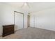 Bedroom with carpet, window, ceiling fan, and wooden furniture with drawers at 4332 W Monte Cristo W Ave, Glendale, AZ 85306