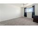 Bedroom with carpet, window with drapes, a ceiling fan, and dark furniture at 4332 W Monte Cristo W Ave, Glendale, AZ 85306