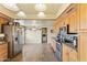 Bright kitchen with stainless steel appliances, wood cabinets, and tile flooring at 4332 W Monte Cristo W Ave, Glendale, AZ 85306