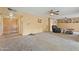 Spacious living room featuring tan carpet, ceiling fans, and a double door entry at 4332 W Monte Cristo W Ave, Glendale, AZ 85306