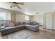 Bright and airy living room featuring a large gray sectional sofa and tile floors at 4332 W Monte Cristo W Ave, Glendale, AZ 85306