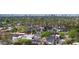 Panoramic aerial perspective with palm trees of residential neighborhood, buildings, and city skyline in the distance at 4440 E Campbell Ave, Phoenix, AZ 85018