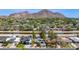 Scenic aerial shot of a charming neighborhood with homes near a canal and beautiful mountain views at 4440 E Campbell Ave, Phoenix, AZ 85018