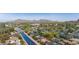 Beautiful aerial view showcasing homes in neighborhood near canal, mountains, and surrounding lush greenery at 4440 E Campbell Ave, Phoenix, AZ 85018