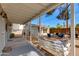 Inviting covered patio with a swing and an expansive pea gravel yard, offering a comfortable outdoor retreat at 4440 E Campbell Ave, Phoenix, AZ 85018