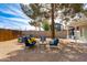 Inviting backyard patio with comfortable seating, gravel ground cover, and a large shade tree for relaxing outdoors at 4440 E Campbell Ave, Phoenix, AZ 85018