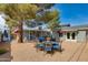 Outdoor living space featuring gravel, comfortable seating, mature trees, and a dining set for gatherings at 4440 E Campbell Ave, Phoenix, AZ 85018