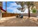 Secluded backyard oasis featuring stylish seating, gravel ground cover, and a wood fence for added privacy at 4440 E Campbell Ave, Phoenix, AZ 85018