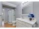 Features curved glass shower, wood floor, white cabinets and marble countertops at 4440 E Campbell Ave, Phoenix, AZ 85018