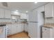 Bright kitchen features white cabinets, tile countertops, and modern appliances at 4440 E Campbell Ave, Phoenix, AZ 85018