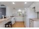 Well-lit kitchen features white cabinets, tile countertops, and modern appliances at 4440 E Campbell Ave, Phoenix, AZ 85018