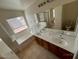 Spacious bathroom features double sinks, large tub, and separate shower area at 46037 W Starlight Dr, Maricopa, AZ 85139