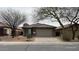 Charming single-story home featuring a neutral color scheme, well-kept landscaping, and a two-car garage at 46037 W Starlight Dr, Maricopa, AZ 85139