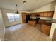 Open-concept kitchen with an island, tile flooring, natural lighting, and matching appliances at 46037 W Starlight Dr, Maricopa, AZ 85139