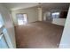 Open-concept living room with carpet flooring and sliding glass doors at 46037 W Starlight Dr, Maricopa, AZ 85139
