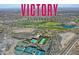 Aerial view of Victory at Verrado showcasing community pools, golf course, and tennis courts at 5581 N 206Th Ave, Buckeye, AZ 85396