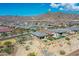 Panoramic aerial shot of a community surrounded by mountains on a clear, sunny day at 5581 N 206Th Ave, Buckeye, AZ 85396