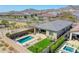 Aerial view of a backyard showcasing a modern pool, patio area, and artificial turf at 5581 N 206Th Ave, Buckeye, AZ 85396