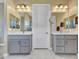 Bathroom featuring double vanity sinks with quartz countertops, gray cabinetry, and modern lighting at 5581 N 206Th Ave, Buckeye, AZ 85396