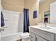 Bathroom features a white vanity, tub, and shower with blue accents creating a clean and modern space at 5581 N 206Th Ave, Buckeye, AZ 85396