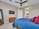 Well-lit bedroom featuring a TV, dresser, and a view into the ensuite bathroom at 5581 N 206Th Ave, Buckeye, AZ 85396