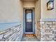 Up close view of home's front door, stone accents, and exterior light fixture at 5581 N 206Th Ave, Buckeye, AZ 85396