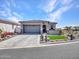 Charming single-story home featuring a paver driveway, stone accents, and desert landscaping at 5581 N 206Th Ave, Buckeye, AZ 85396