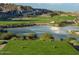 Scenic golf course view featuring a tranquil pond and lush green landscape at 5581 N 206Th Ave, Buckeye, AZ 85396