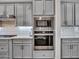 This modern kitchen features gray cabinets, stainless steel appliances, and a subway tile backsplash at 5581 N 206Th Ave, Buckeye, AZ 85396