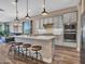 Modern kitchen features a large island, stainless steel appliances, and wood flooring at 5581 N 206Th Ave, Buckeye, AZ 85396