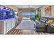 This living room features an aquarium, a sectional, and a slider to the outdoor space at 5581 N 206Th Ave, Buckeye, AZ 85396